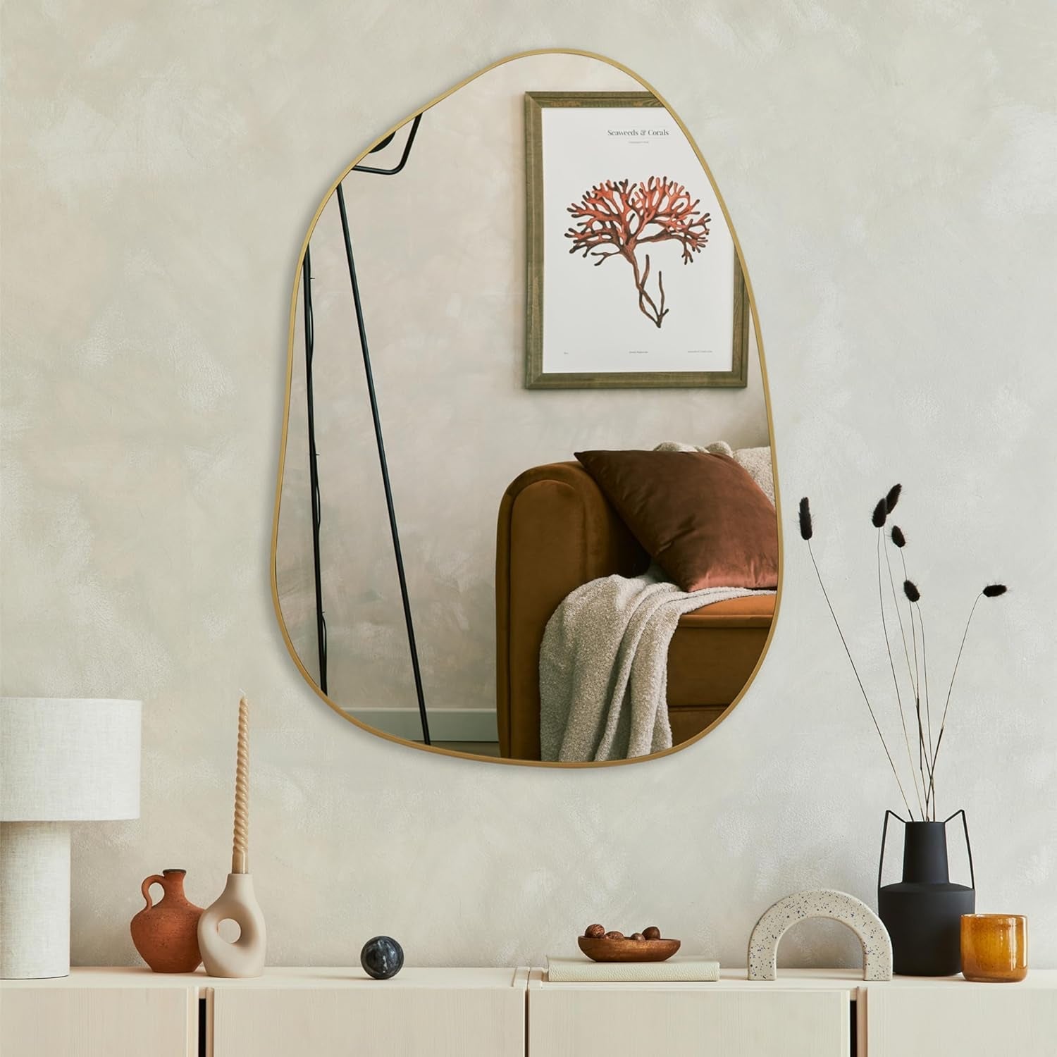 Modern irregular wall mirror with gold frame, perfect for living room or entryway décor.
