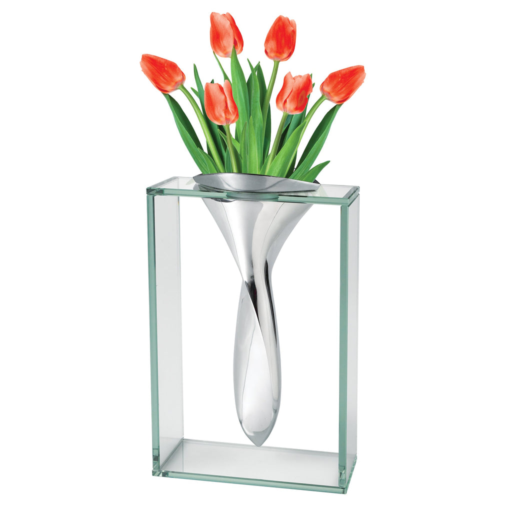 Modern glass and metal vase with red tulips for stylish contemporary home decor.
