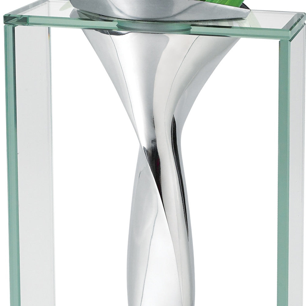 Close-up modern glass and metal vase with sleek twisted design for elegant decor.
