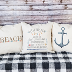 Coastal throw pillow set with beach, anchor, and ocean quotes for nautical home decor.
