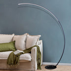 Modern curved floor lamp with sleek arc design beside sofa