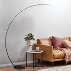 Elegant arc floor lamp beside sofa and coffee table