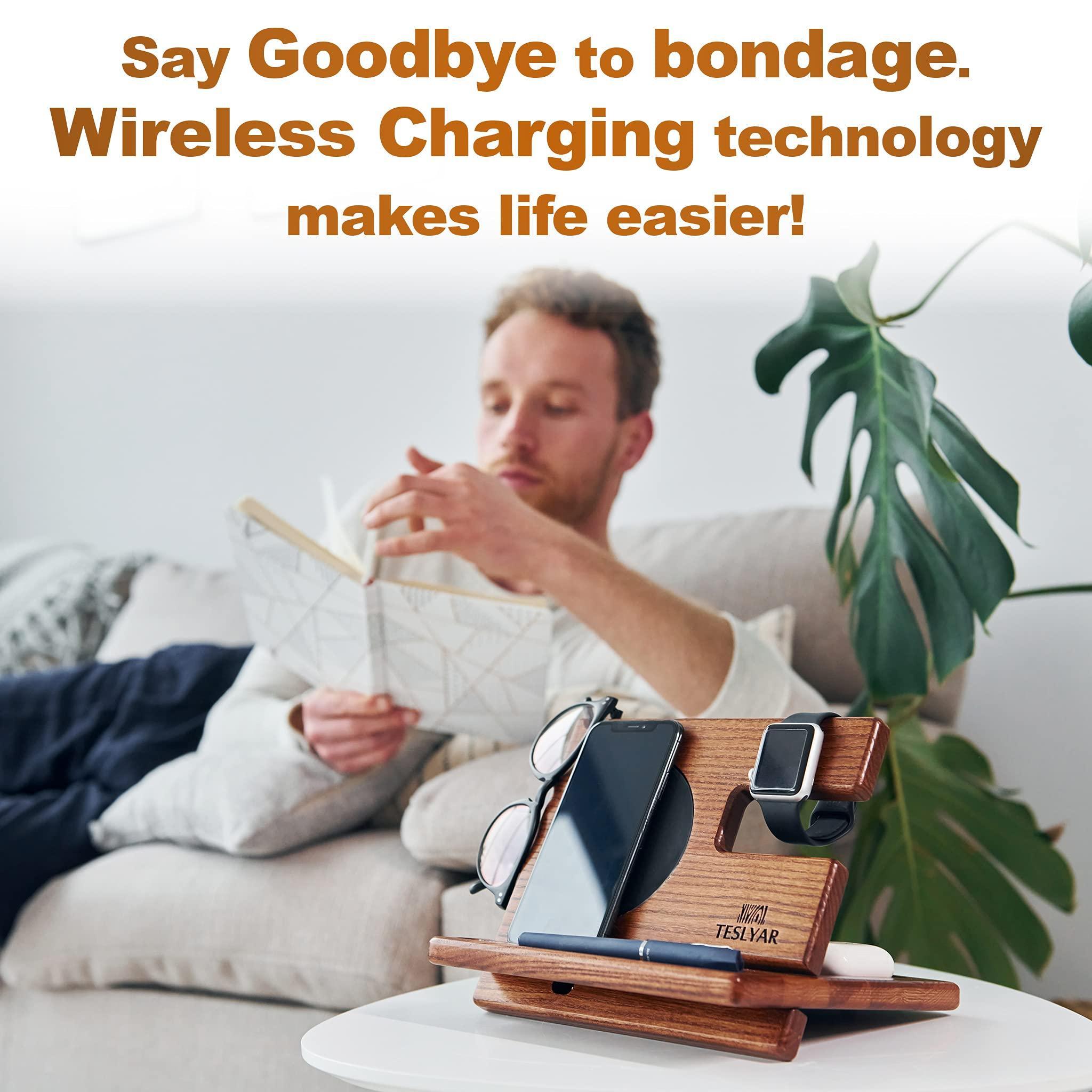 Man relaxing with book beside wooden wireless charging station