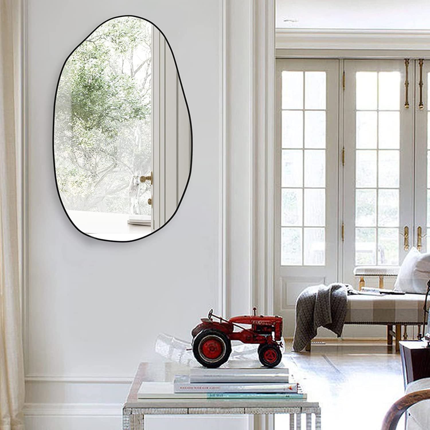 Irregular oval wall mirror with black frame, perfect for living room, hallway, or entryway decor.
