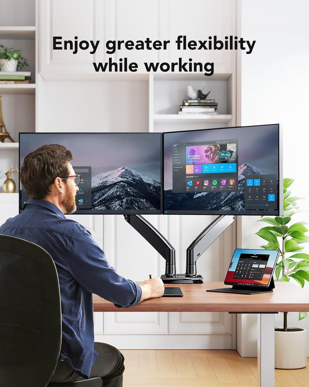 Man working on dual monitors with adjustable desk mount stand