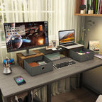 Computer desk setup with monitor stand and storage drawers
