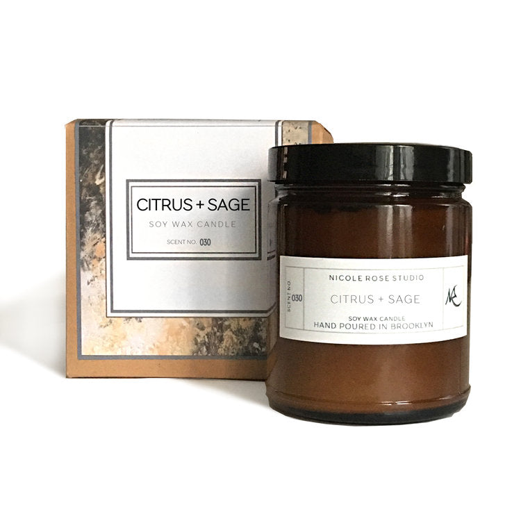 Citrus and sage soy candle in amber jar, refreshing natural home fragrance.
