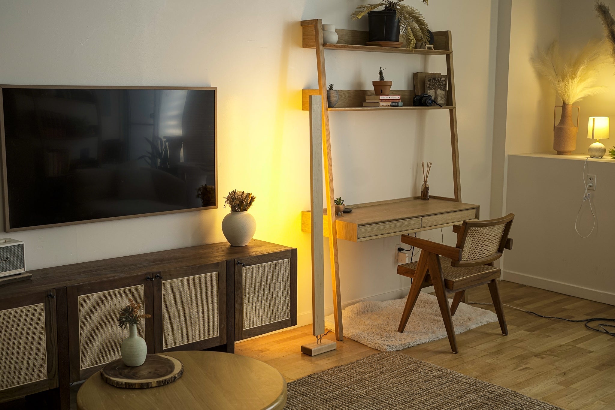 Warm yellow LED corner floor lamp with wooden base for cozy living room lighting.
