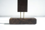 Sturdy dark wooden base for modern LED corner floor lamp design.
