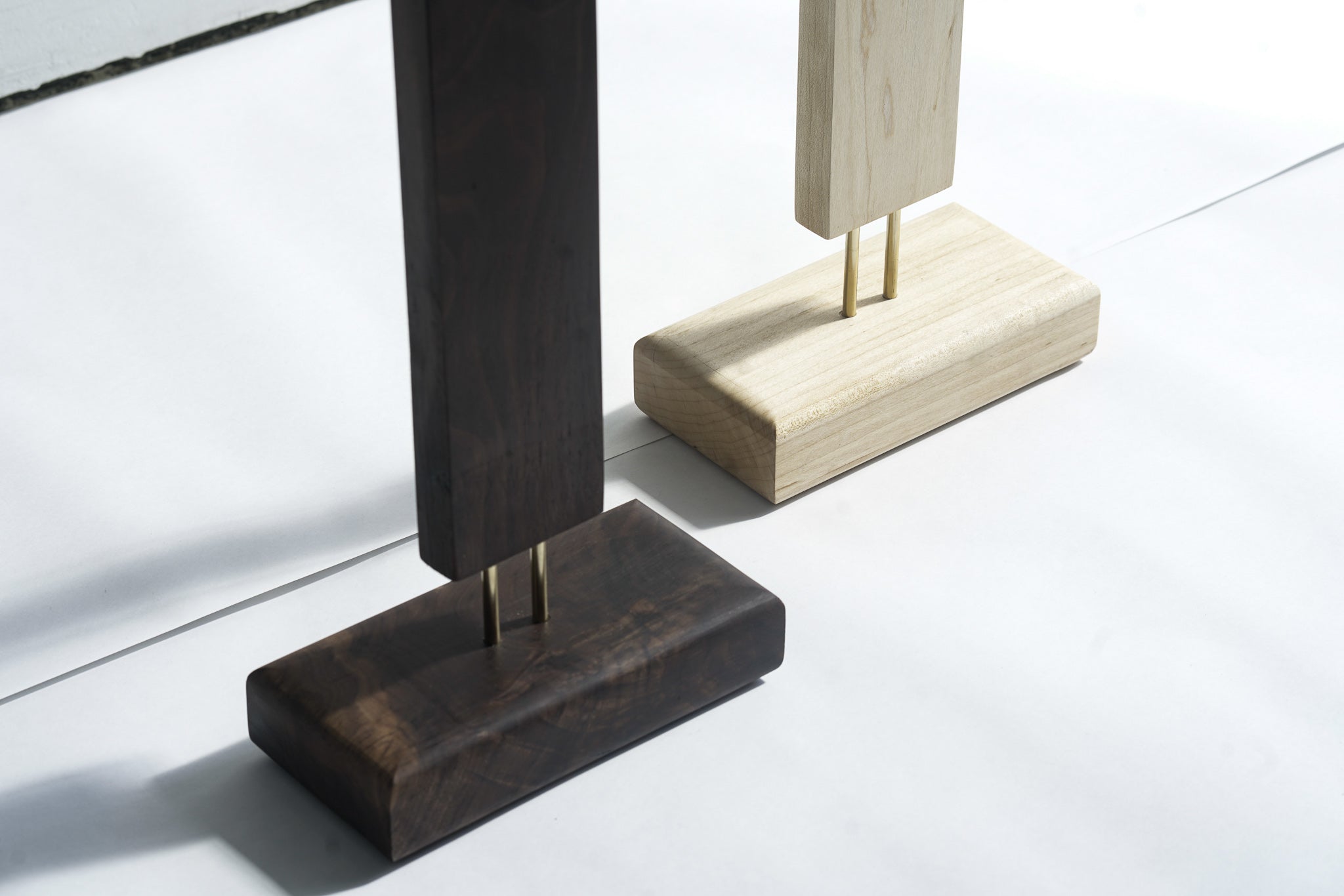 Wooden base LED corner floor lamp in dark and light finish for modern interiors.
