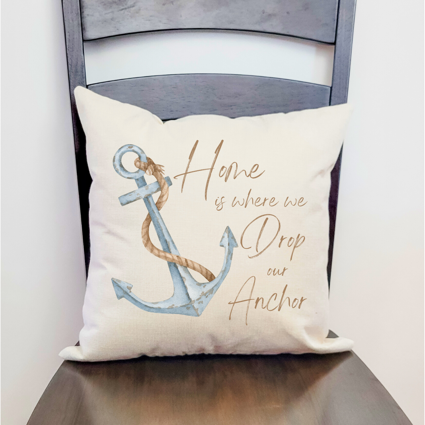 Nautical pillow with anchor design and “Home is where we drop our anchor” quote.
