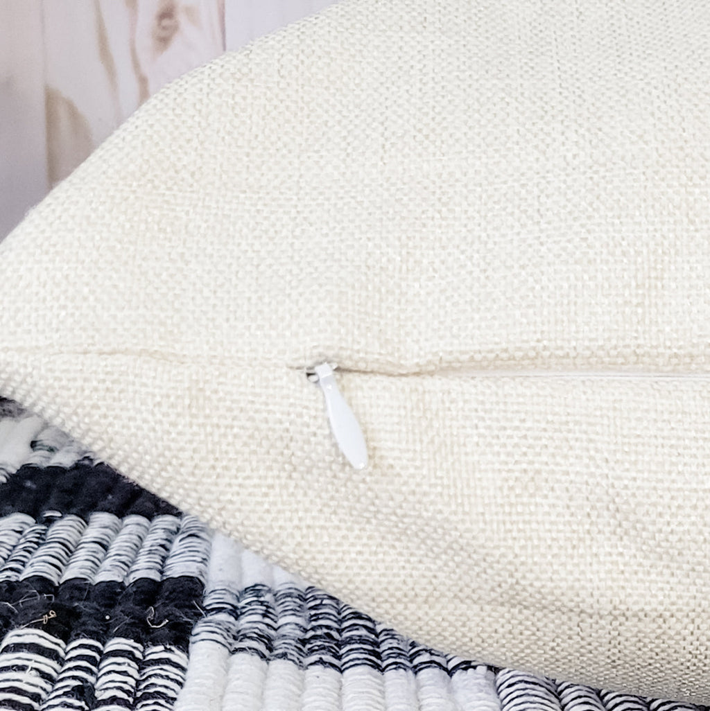 Beige pillow cover with hidden zipper closure for easy use and coastal home decor.
