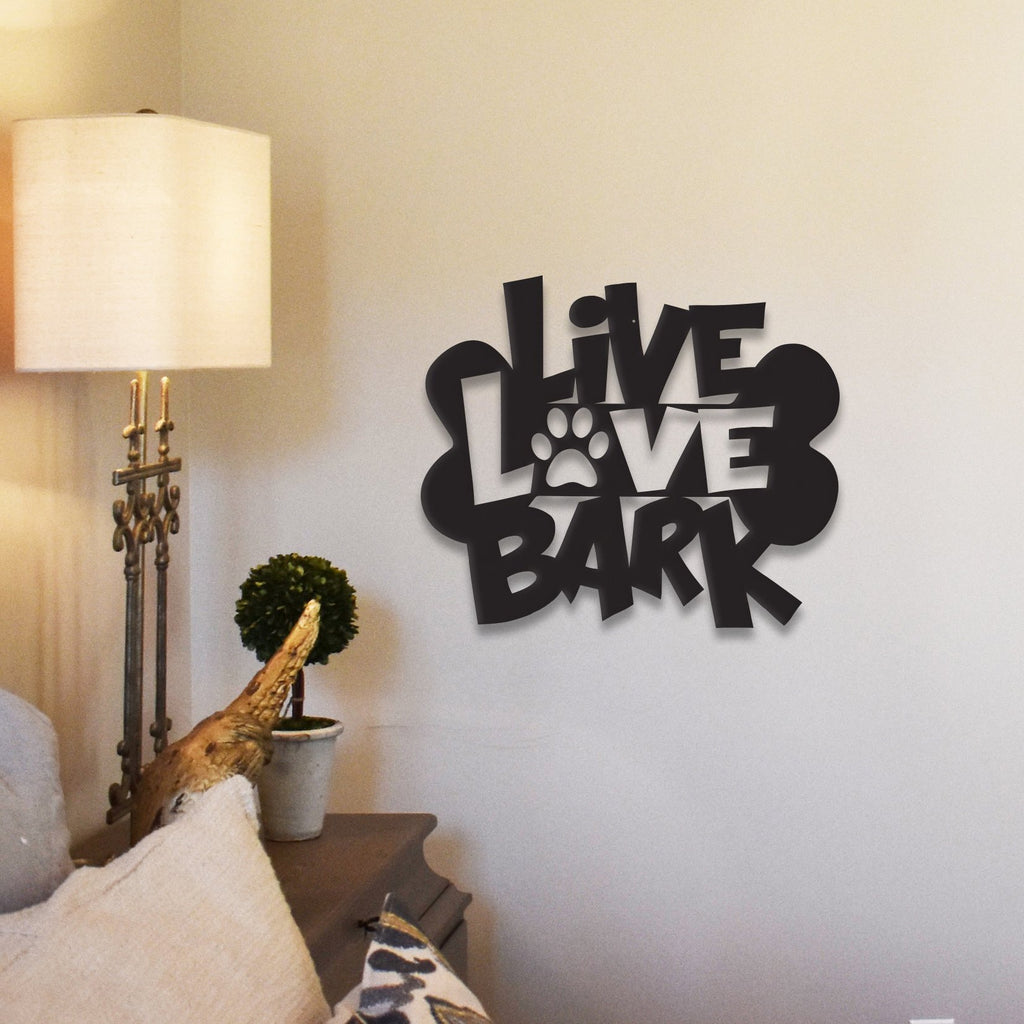 Black "Live Love Bark" wall decor with paw print design