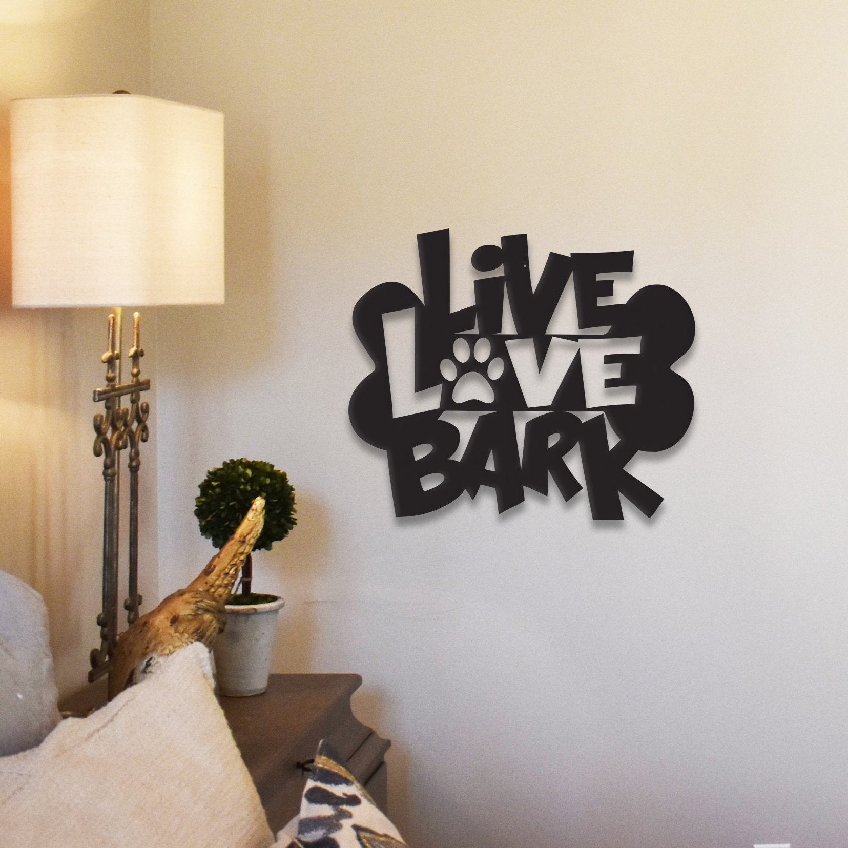 Black "Live Love Bark" wall decor with paw print design