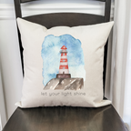Coastal pillow cover with red lighthouse design and quote for nautical home decor.
