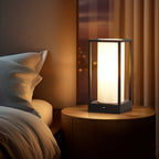Modern bedside table lamp with rectangular shade and warm light