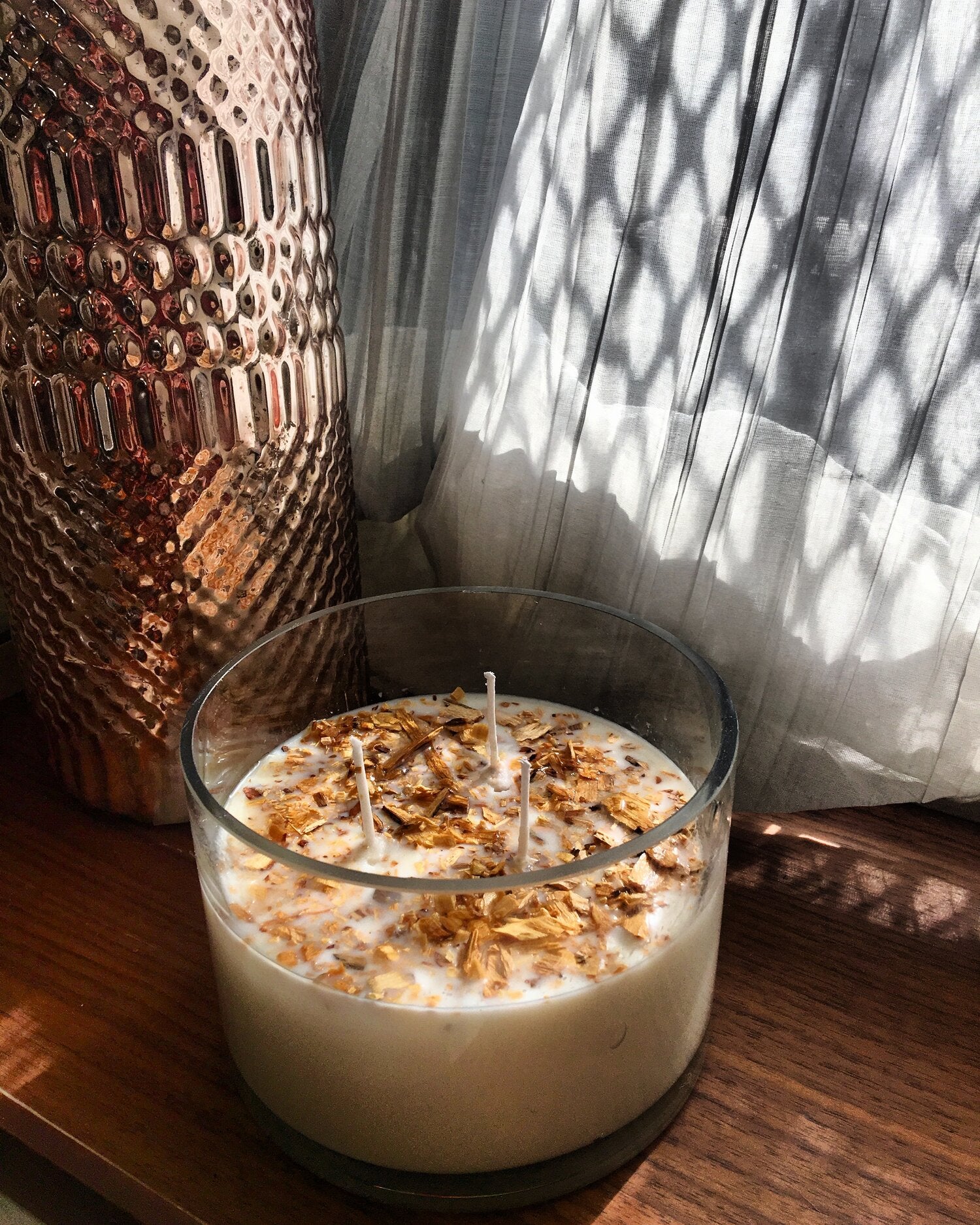 Handmade 3-wick glass candle with dried floral topping, cozy home décor.
