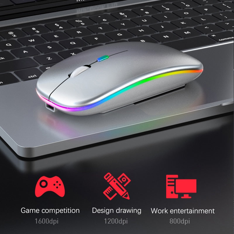 Silver wireless LED mouse placed on laptop touchpad for gaming and work