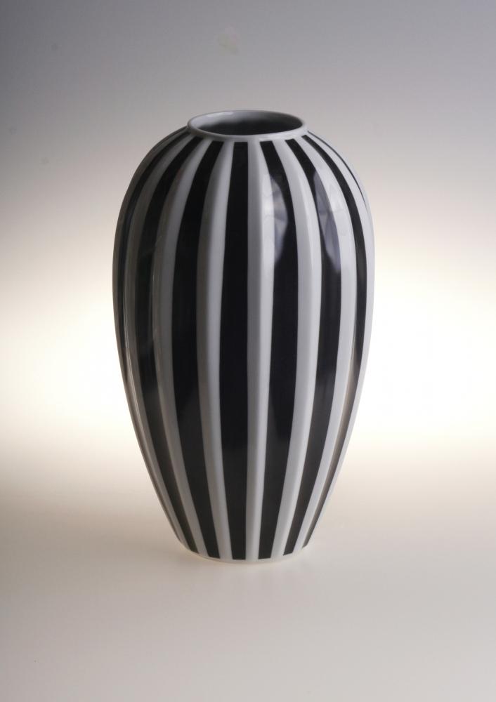Elegant black and white striped ceramic vase with modern minimalist design.
