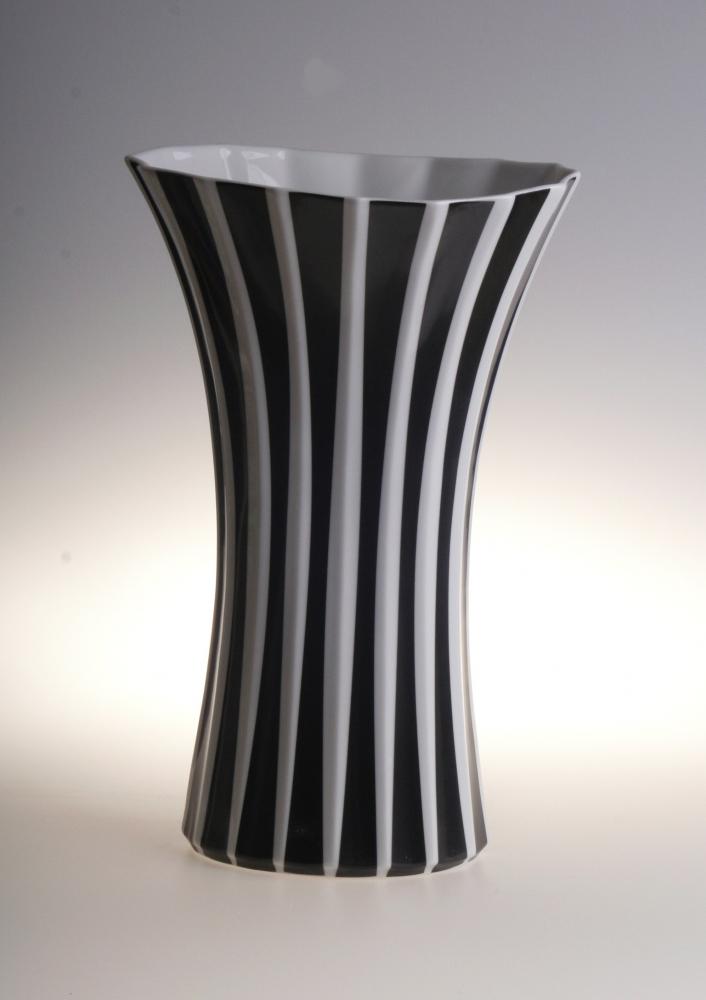 Elegant black and white striped ceramic vase with modern flared design for stylish decor.
