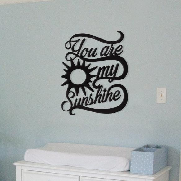Black "You are my Sunshine" wall decor on light blue wall