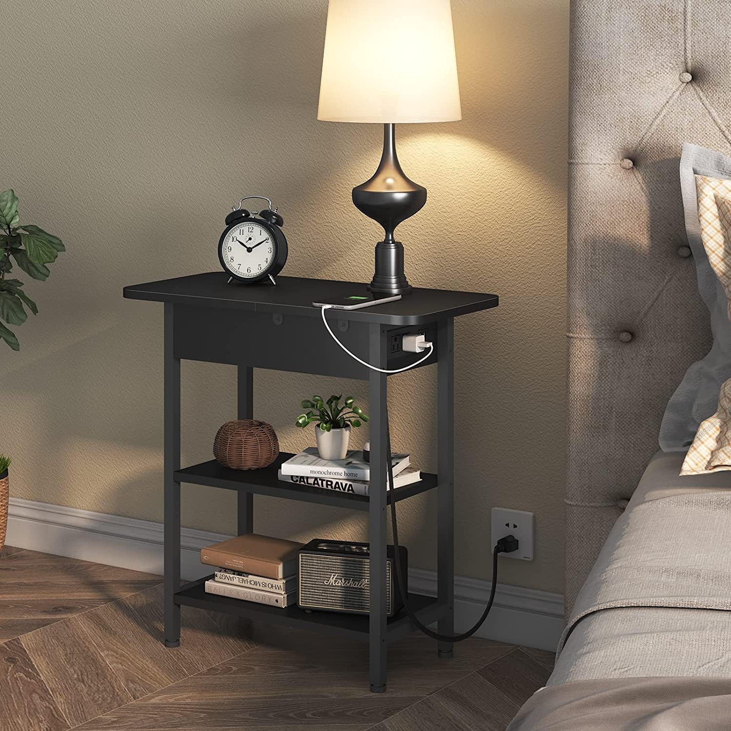 Black nightstand with shelves and built-in charging station for bedroom storage.
