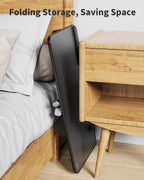 Foldable laptop desk stand stored beside bed and nightstand