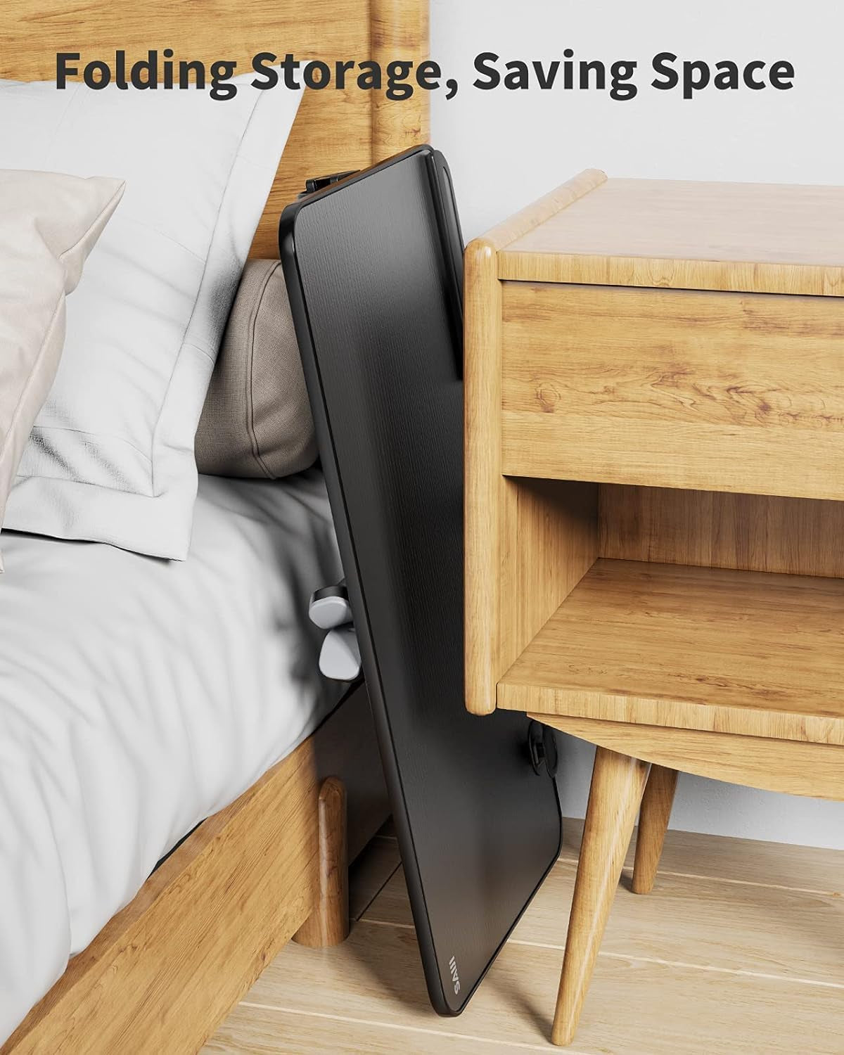 Foldable laptop desk stand stored beside bed and nightstand