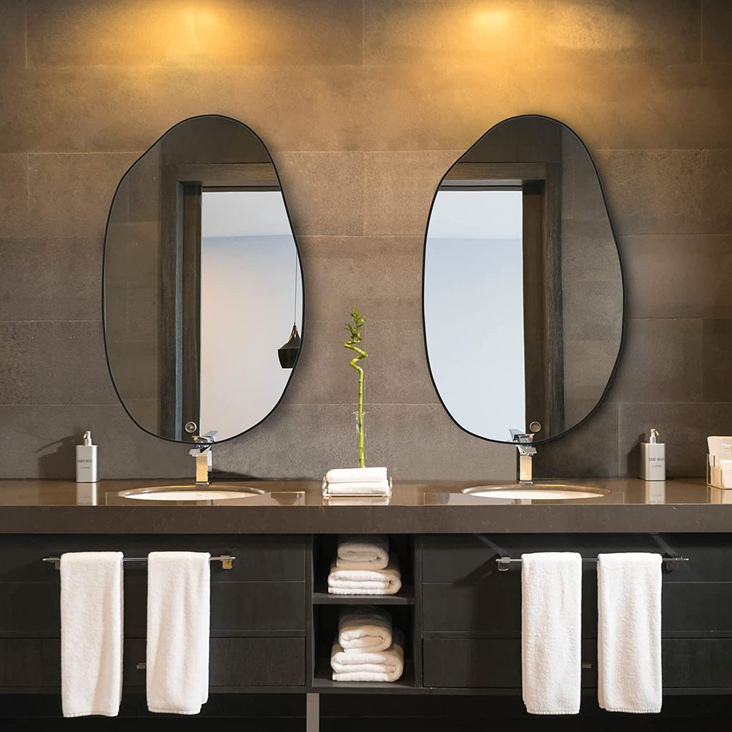 Set of two irregular oval wall mirrors with black frames for modern bathroom vanity decor.
