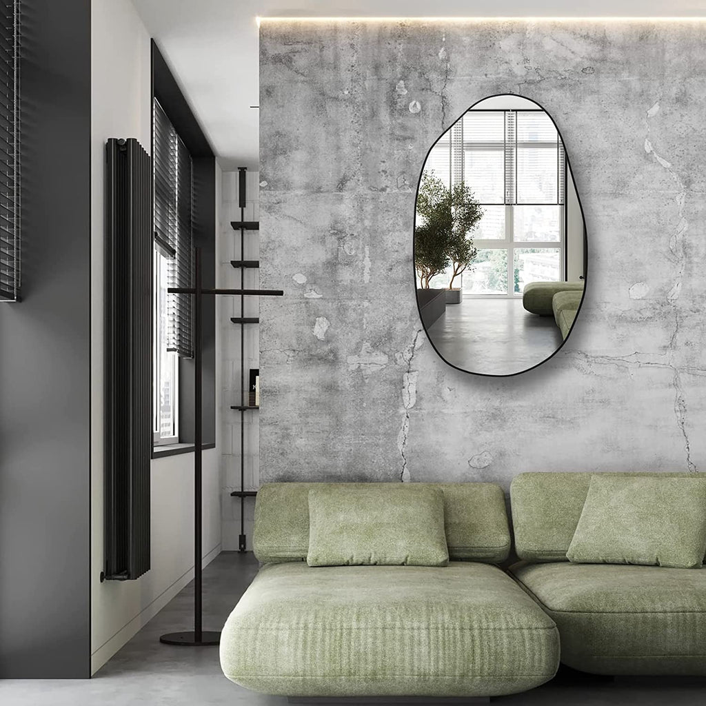 Modern oval wall mirror with black frame, perfect for living room or hallway decor.
