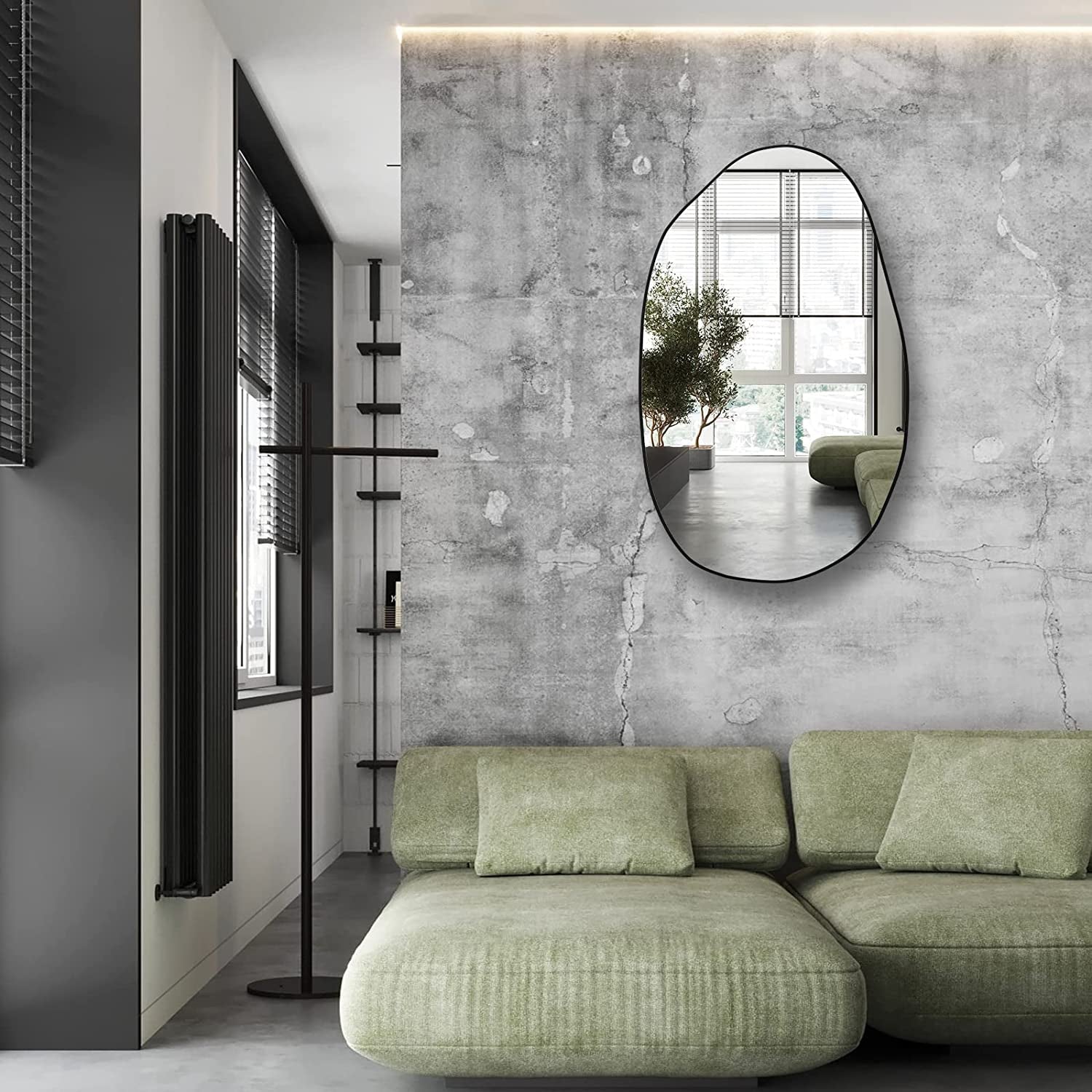 Modern oval wall mirror with black frame, perfect for living room or hallway decor.
