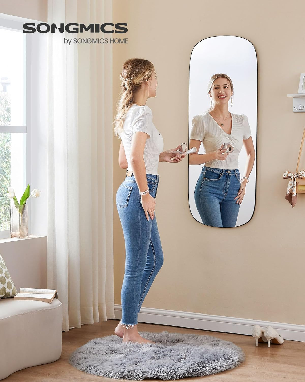Modern wall-mounted full-length mirror with rounded edges for bedroom and dressing area.
