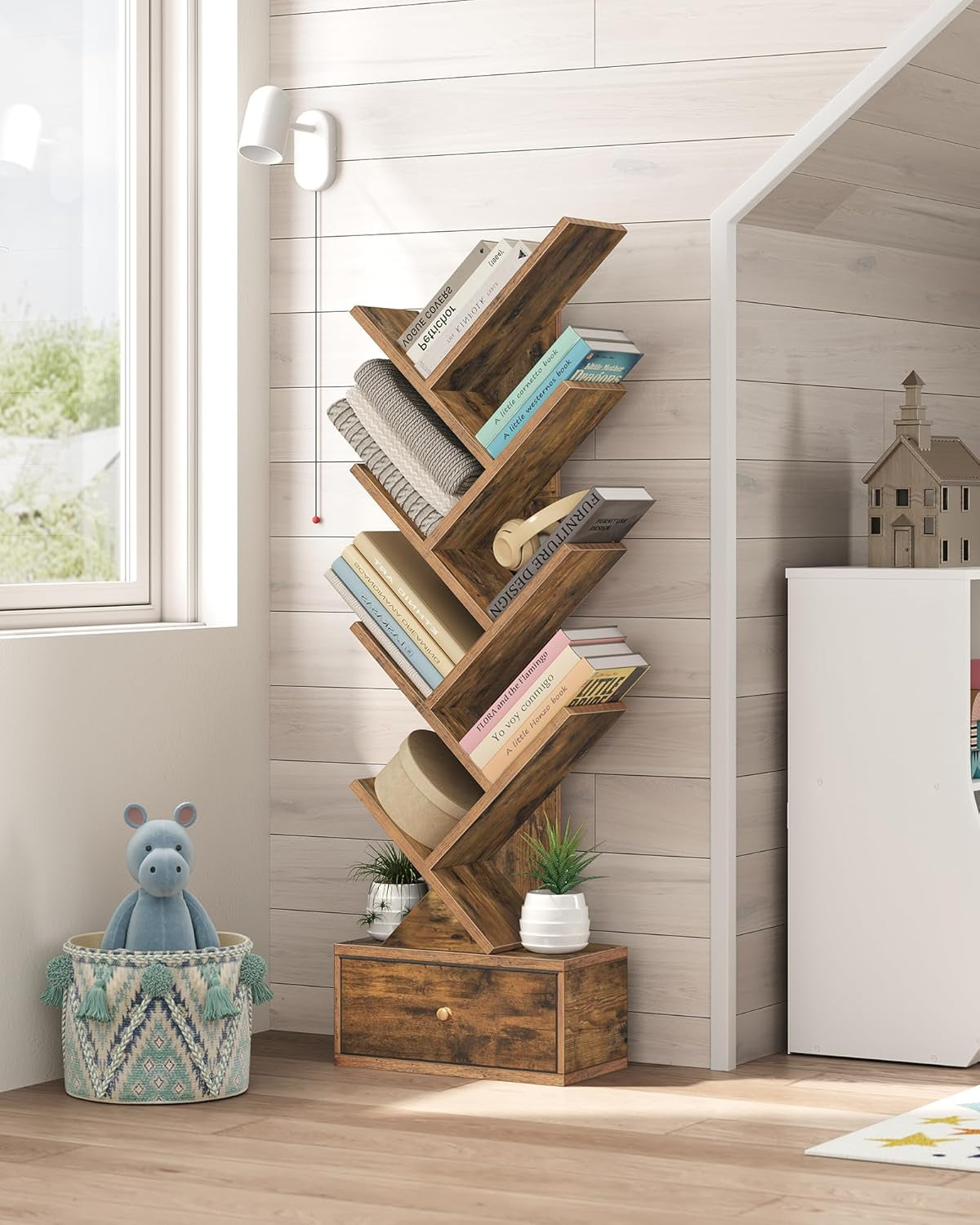 Rustic wooden tree-shaped bookshelf with storage drawer for books and decor display.
