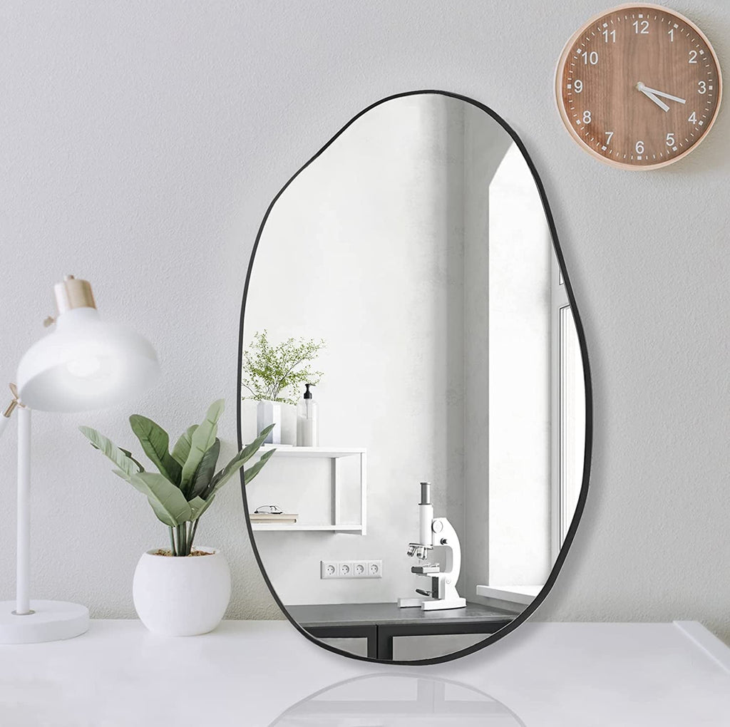 Modern irregular oval wall mirror with black frame, ideal for bedroom, office, or vanity decor.
