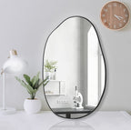 Modern irregular oval wall mirror with black frame, ideal for bedroom, office, or vanity decor.
