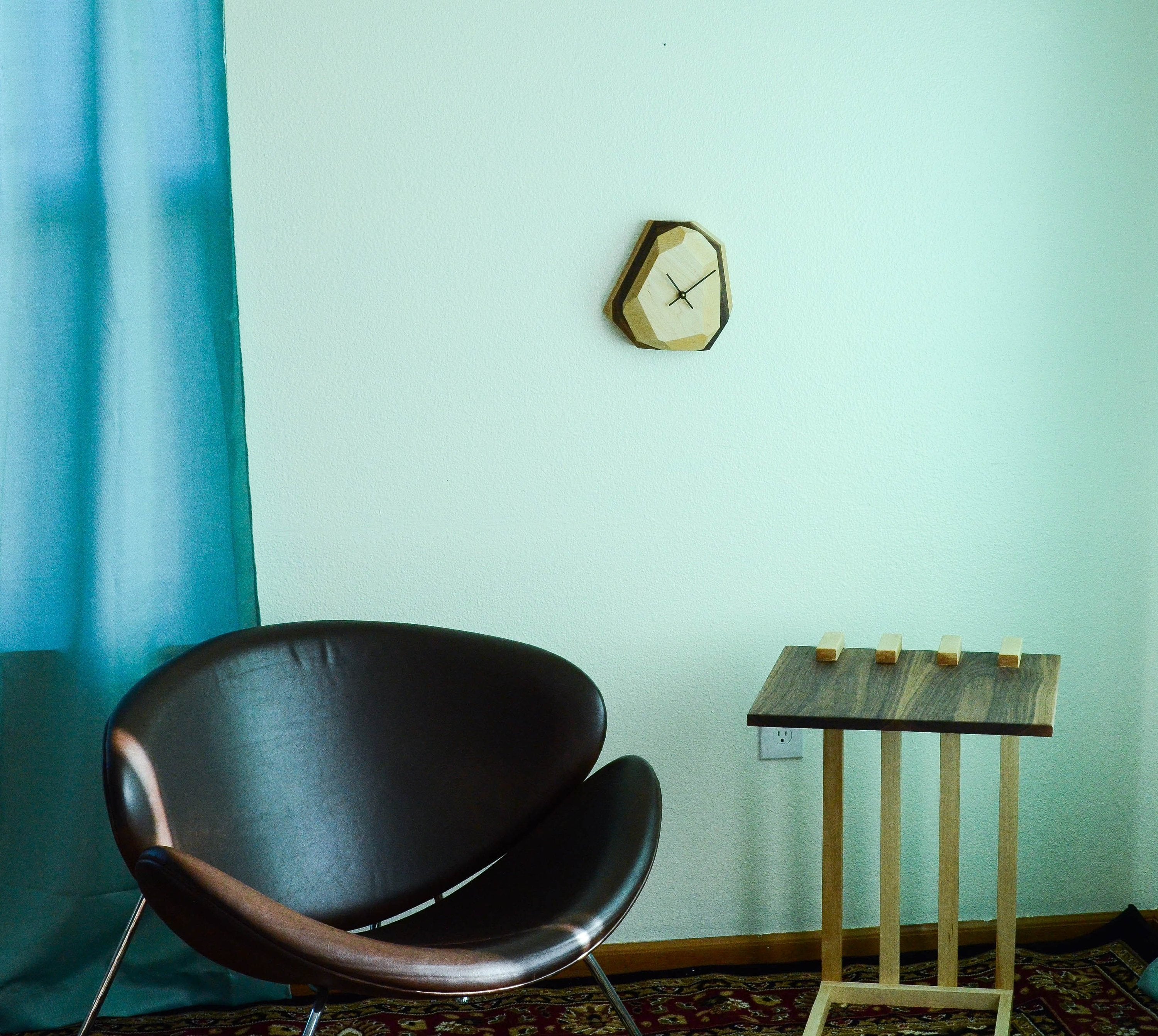 Minimalist geometric wooden wall clock for modern living room decor.
