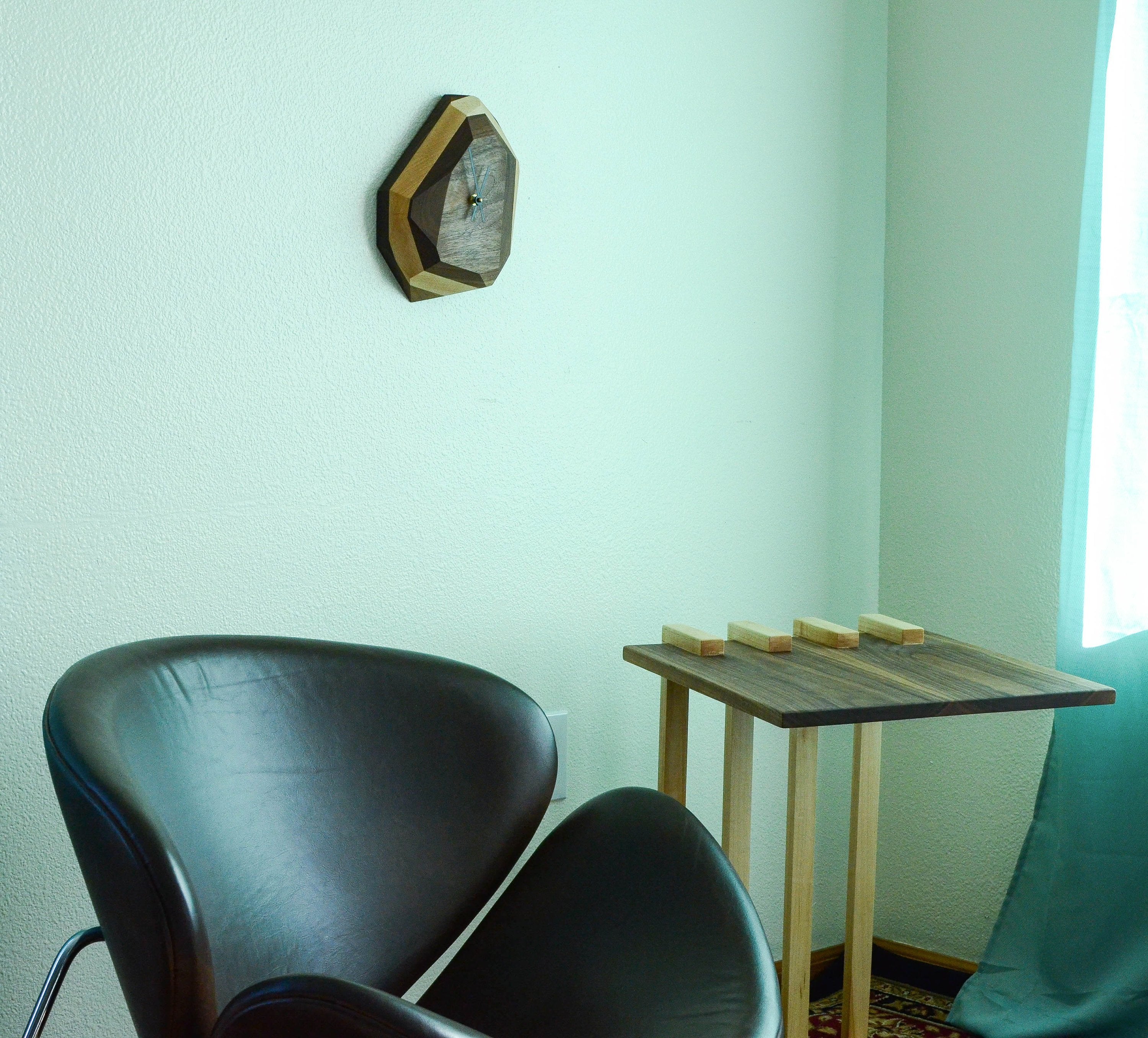 Geometric wooden wall clock with modern design for stylish home interiors.
