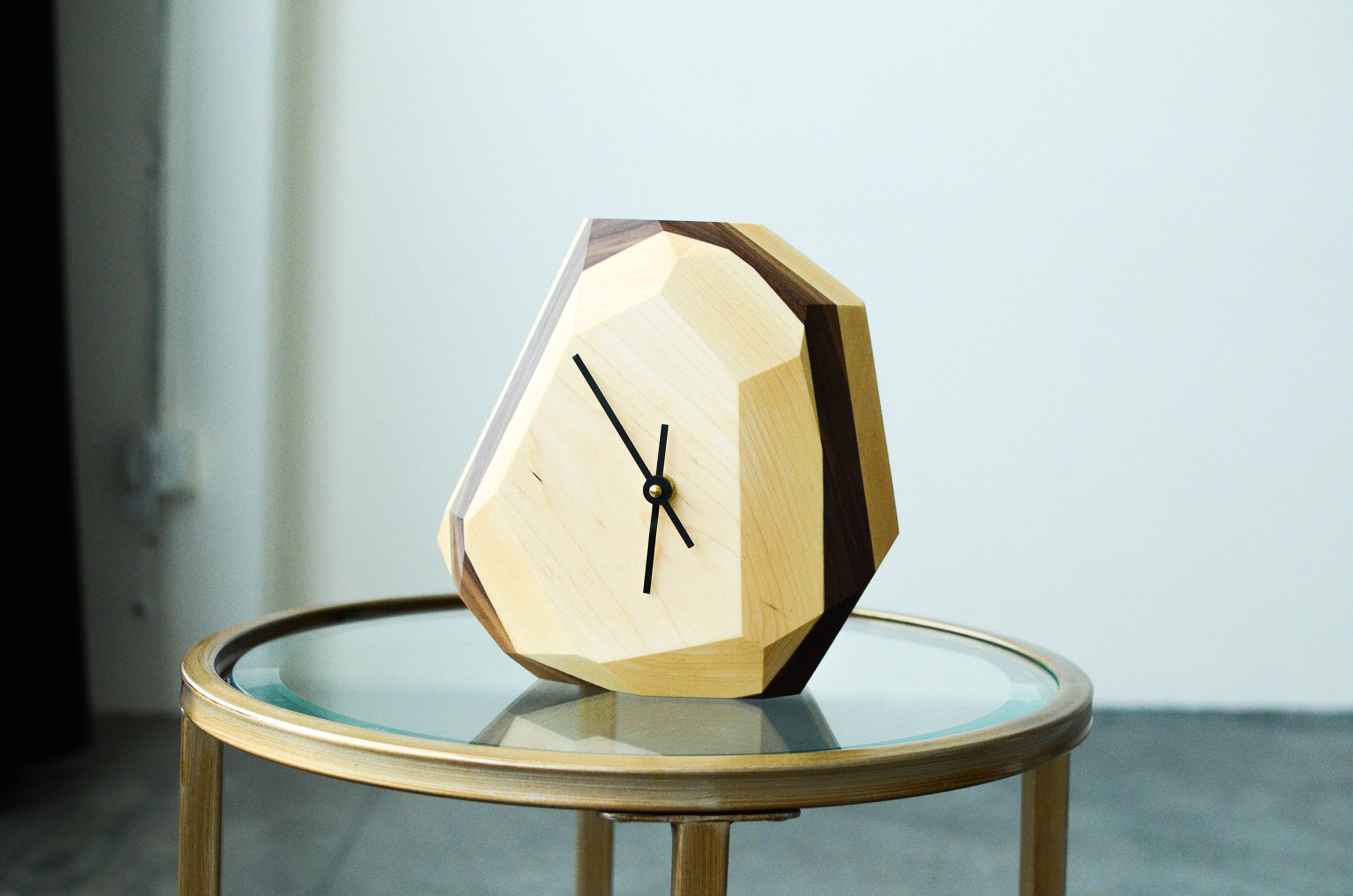 Modern geometric wooden clock with minimalist design for stylish home decor.
