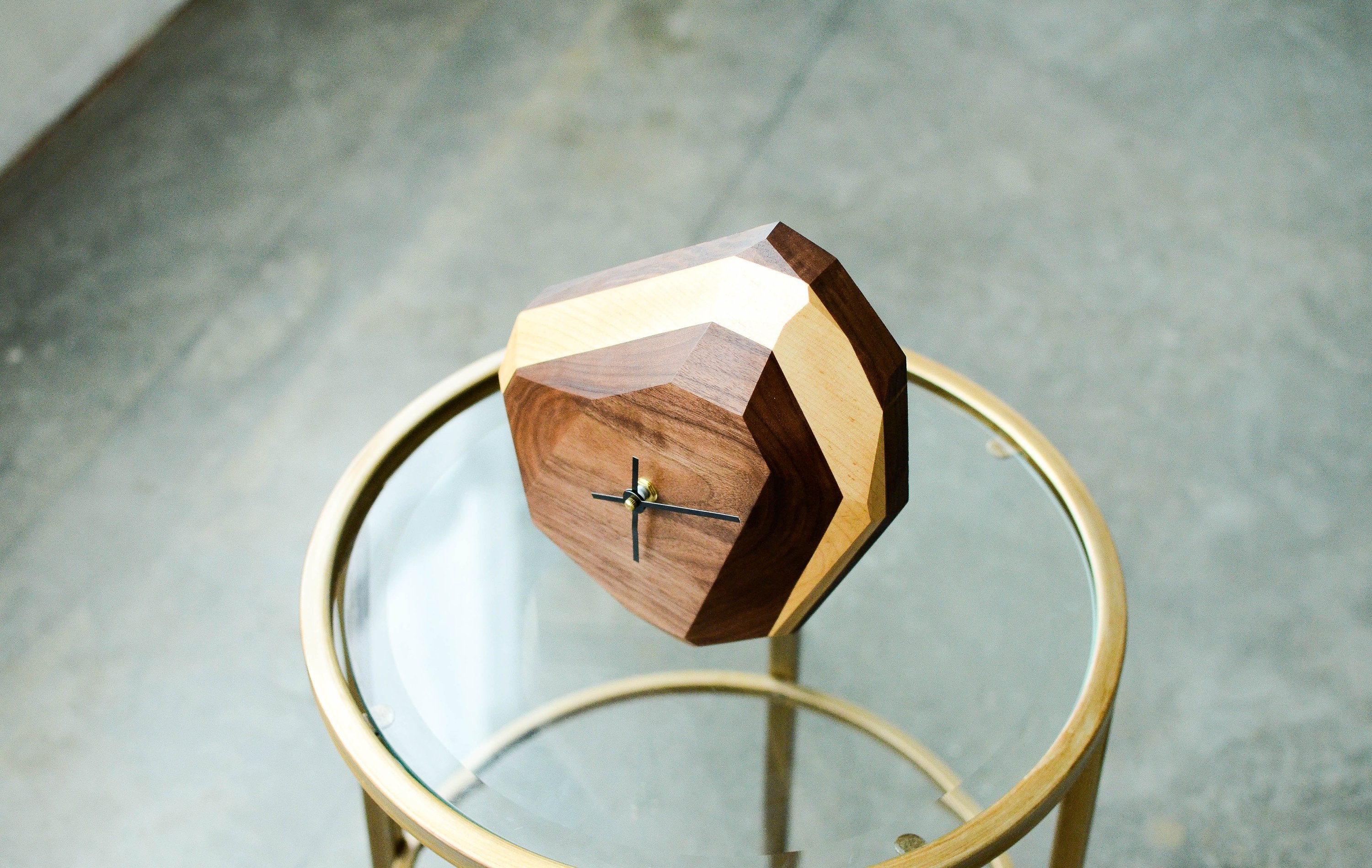 Modern geometric wooden desk clock with unique two-tone design.
