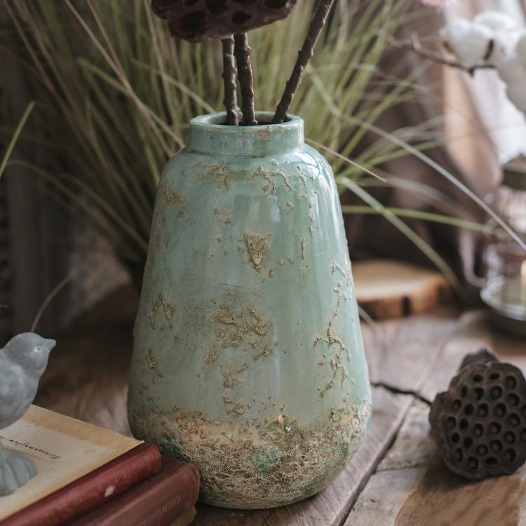 Rustic green ceramic vase with distressed finish for farmhouse and vintage home decor.
